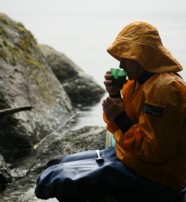  A visitor enjoying a hot drink on the Doubtful Sound New Zealand  